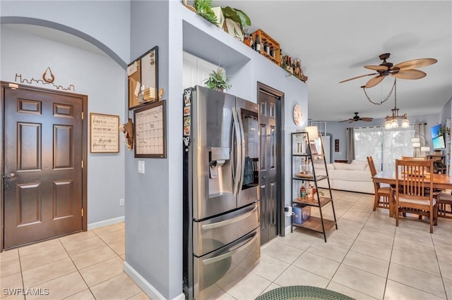 kitchen featuring stainless steel refrigerator with ice dispenser, light tile patterned floors, and ceiling fan