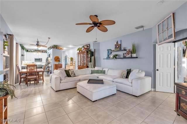 tiled living room with ceiling fan