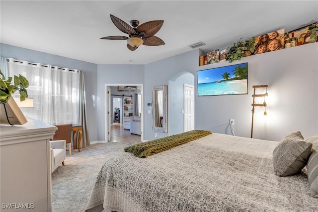 bedroom featuring ceiling fan and light carpet