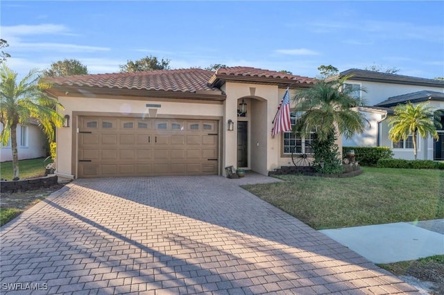 mediterranean / spanish home featuring a garage and a front lawn