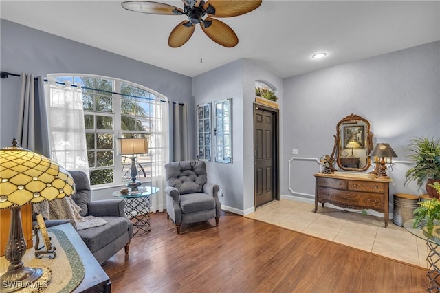 sitting room with ceiling fan and light hardwood / wood-style floors