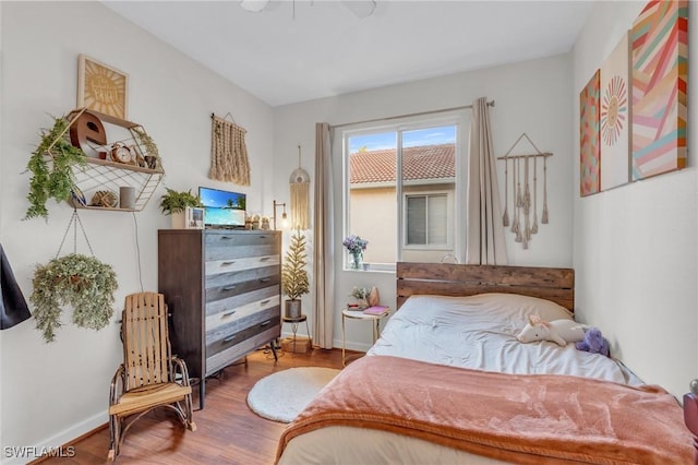 bedroom with wood-type flooring