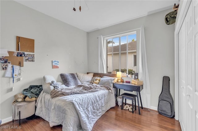 bedroom featuring hardwood / wood-style flooring and a closet