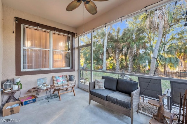 sunroom / solarium featuring ceiling fan