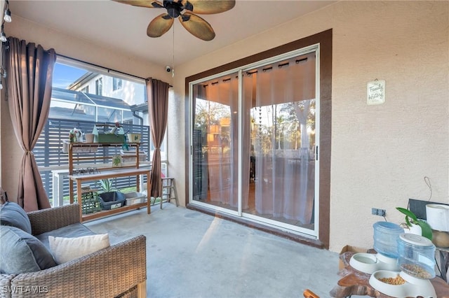 sunroom featuring ceiling fan