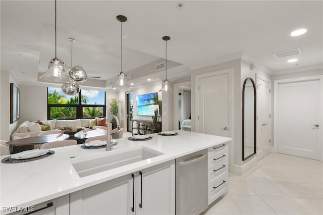 kitchen featuring sink, hanging light fixtures, light tile patterned floors, dishwasher, and white cabinets