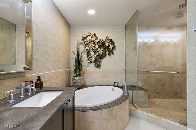 bathroom featuring independent shower and bath, vanity, and tile patterned flooring