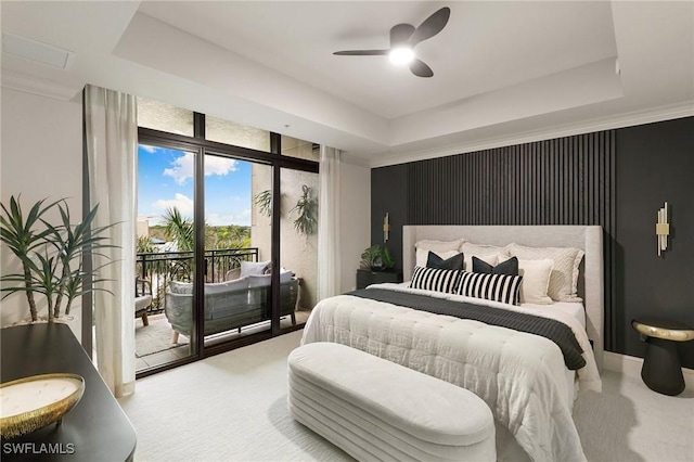 bedroom featuring access to outside, a raised ceiling, and ceiling fan