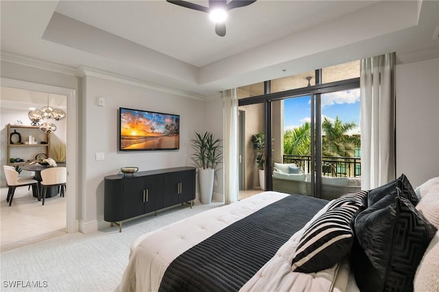 bedroom with crown molding, access to exterior, a tray ceiling, and ceiling fan with notable chandelier