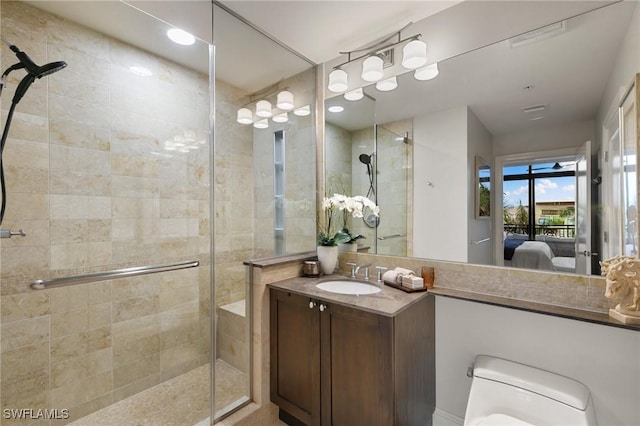 bathroom with an enclosed shower, vanity, and toilet