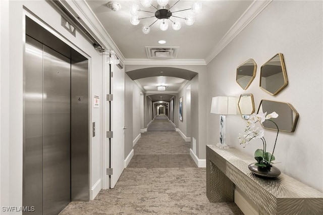 corridor with crown molding and elevator