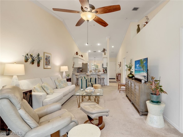 carpeted living room featuring ceiling fan and crown molding