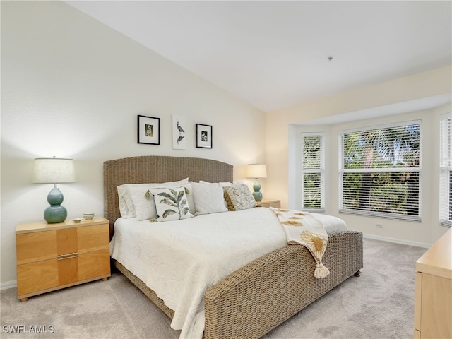 carpeted bedroom featuring lofted ceiling