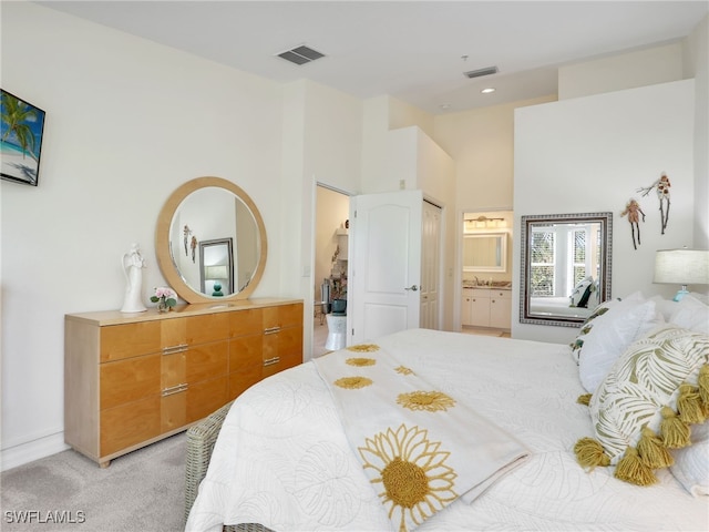 carpeted bedroom with ensuite bath