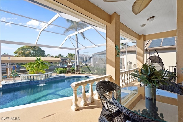 view of swimming pool with a lanai and a patio area