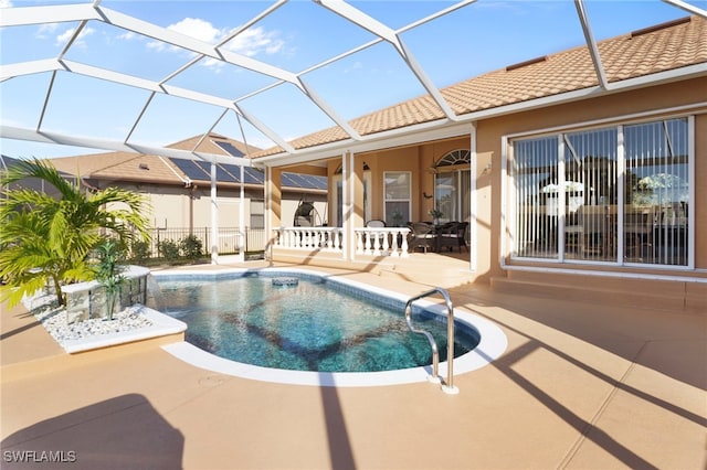 view of swimming pool with a lanai and a patio