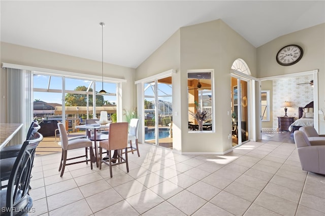 tiled dining space with lofted ceiling