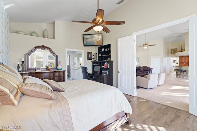 bedroom featuring connected bathroom, ceiling fan, high vaulted ceiling, and light hardwood / wood-style floors