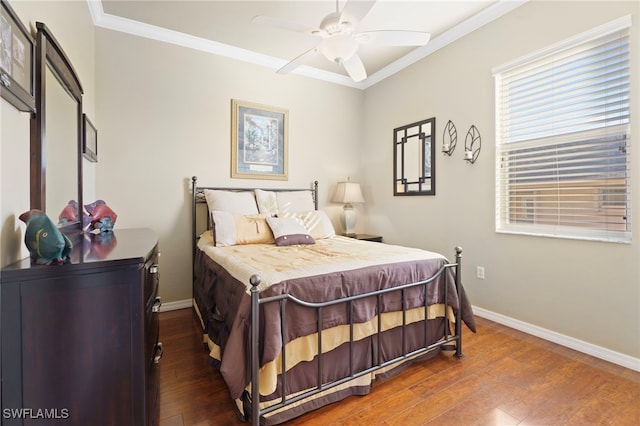 bedroom featuring ceiling fan, ornamental molding, and dark wood-type flooring