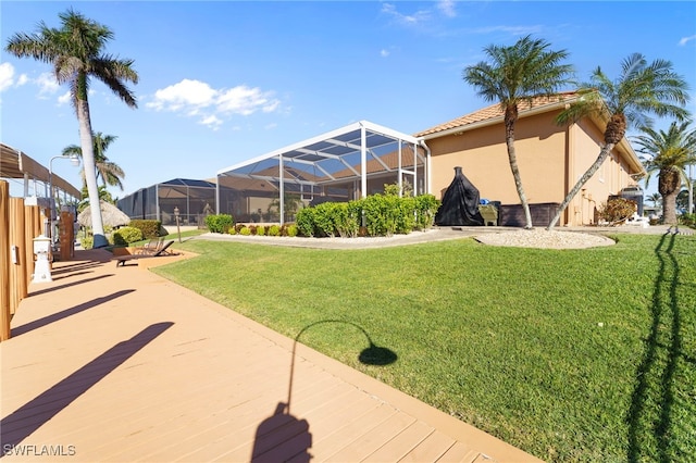 view of yard with glass enclosure