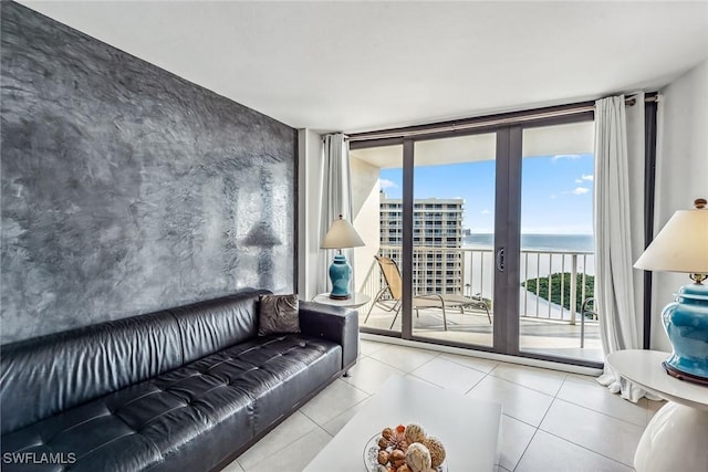 tiled living room with a water view and expansive windows