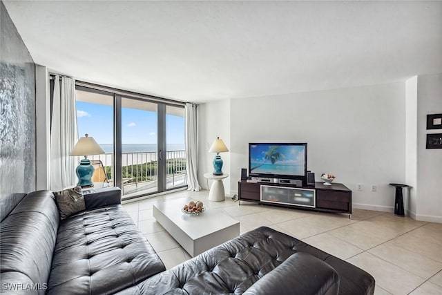 tiled living room featuring floor to ceiling windows