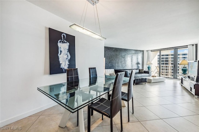 tiled dining area featuring a wall of windows