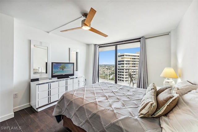 bedroom featuring dark wood-type flooring, ceiling fan, a wall of windows, and access to outside