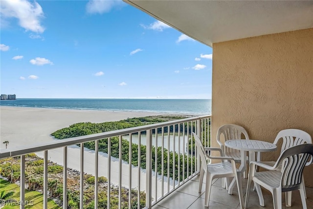 balcony with a water view and a beach view