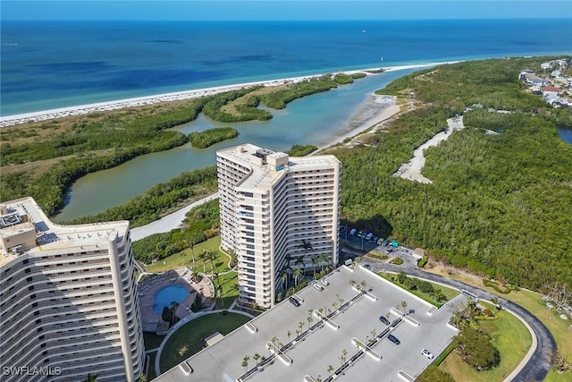 drone / aerial view featuring a water view and a view of the beach