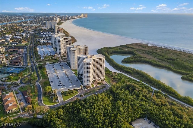 birds eye view of property with a water view and a view of the beach