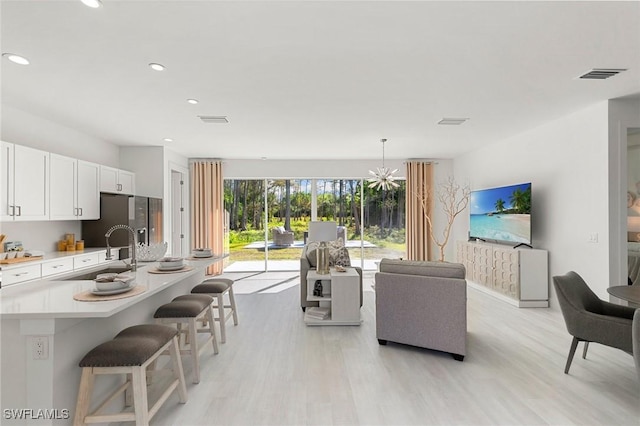 living room featuring light hardwood / wood-style floors and sink