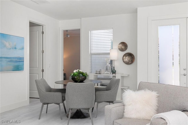 dining space with light hardwood / wood-style floors