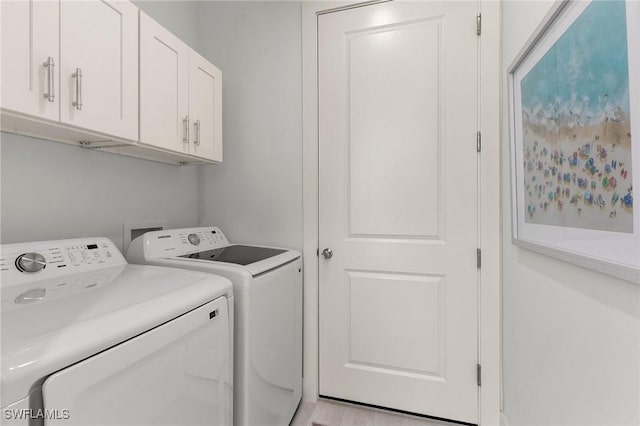 laundry room with cabinets and washing machine and clothes dryer