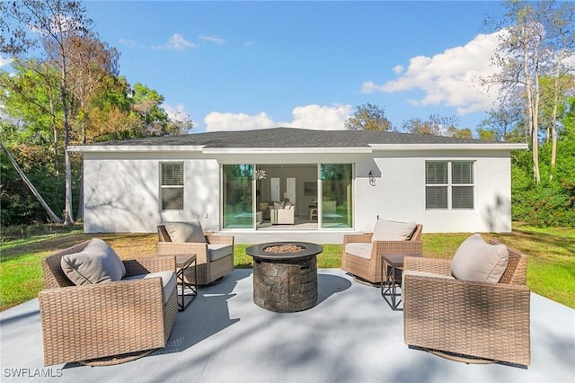 back of property featuring a patio and an outdoor living space with a fire pit