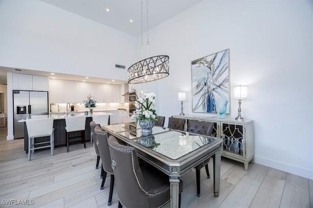 dining room featuring high vaulted ceiling