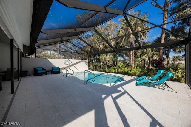 view of pool featuring glass enclosure and a patio