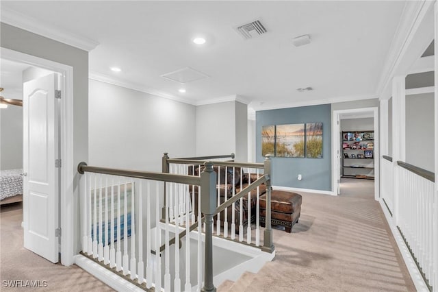 hall with light colored carpet and crown molding