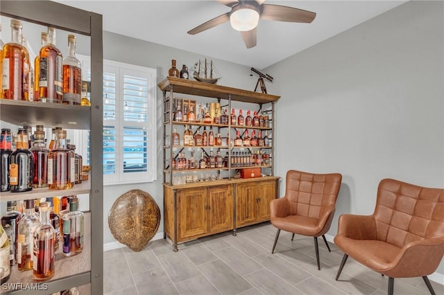 interior space featuring indoor bar and ceiling fan