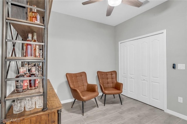 living area featuring ceiling fan