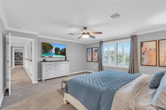 carpeted bedroom with ceiling fan and ornamental molding