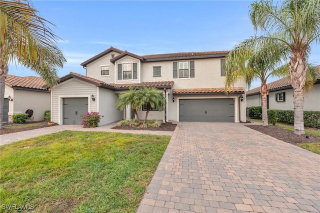 mediterranean / spanish-style house featuring a front yard and a garage