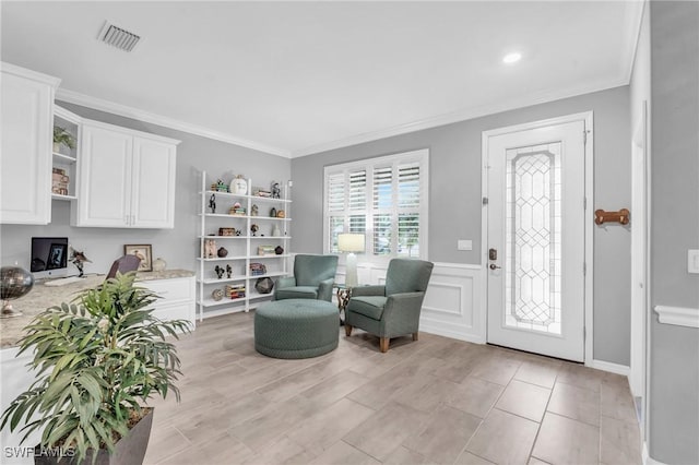 living area with crown molding