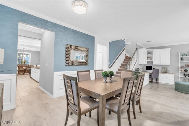 dining room with ornamental molding and sink