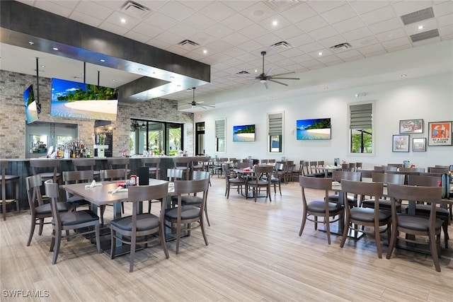 dining space featuring a paneled ceiling, ceiling fan, and a healthy amount of sunlight