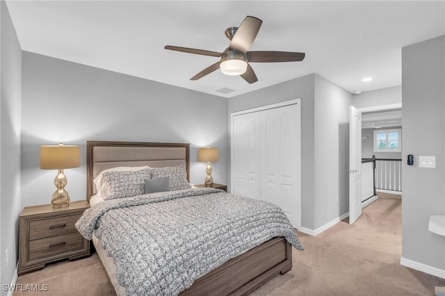 bedroom with light colored carpet, a closet, and ceiling fan