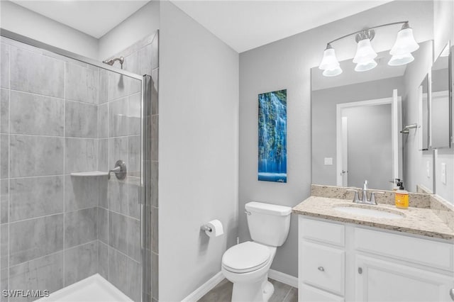 bathroom with a shower with door, vanity, and toilet