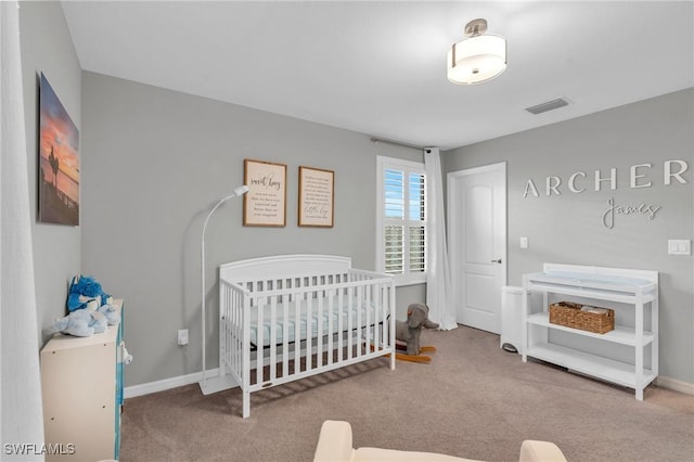 bedroom with carpet floors and a nursery area