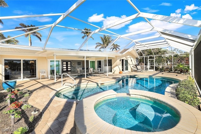 view of pool with glass enclosure, an in ground hot tub, ceiling fan, and a patio