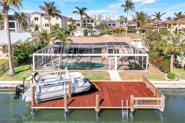 dock area with a lanai and a water view